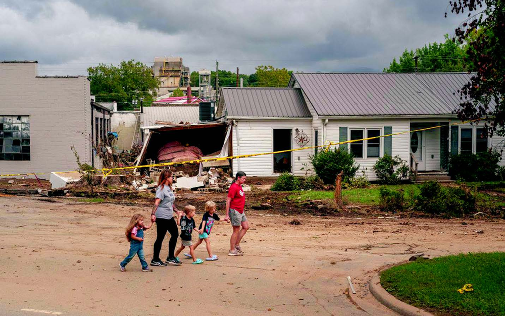 Rescuers navigate through Helene wreckage to locate individuals and reinstate electricity