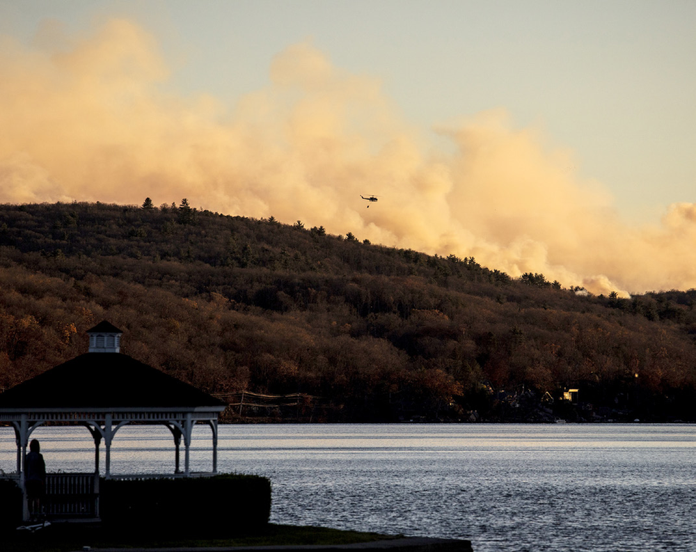 As wildfires rage in New Jersey and New York, rainfall provides minimal respite.